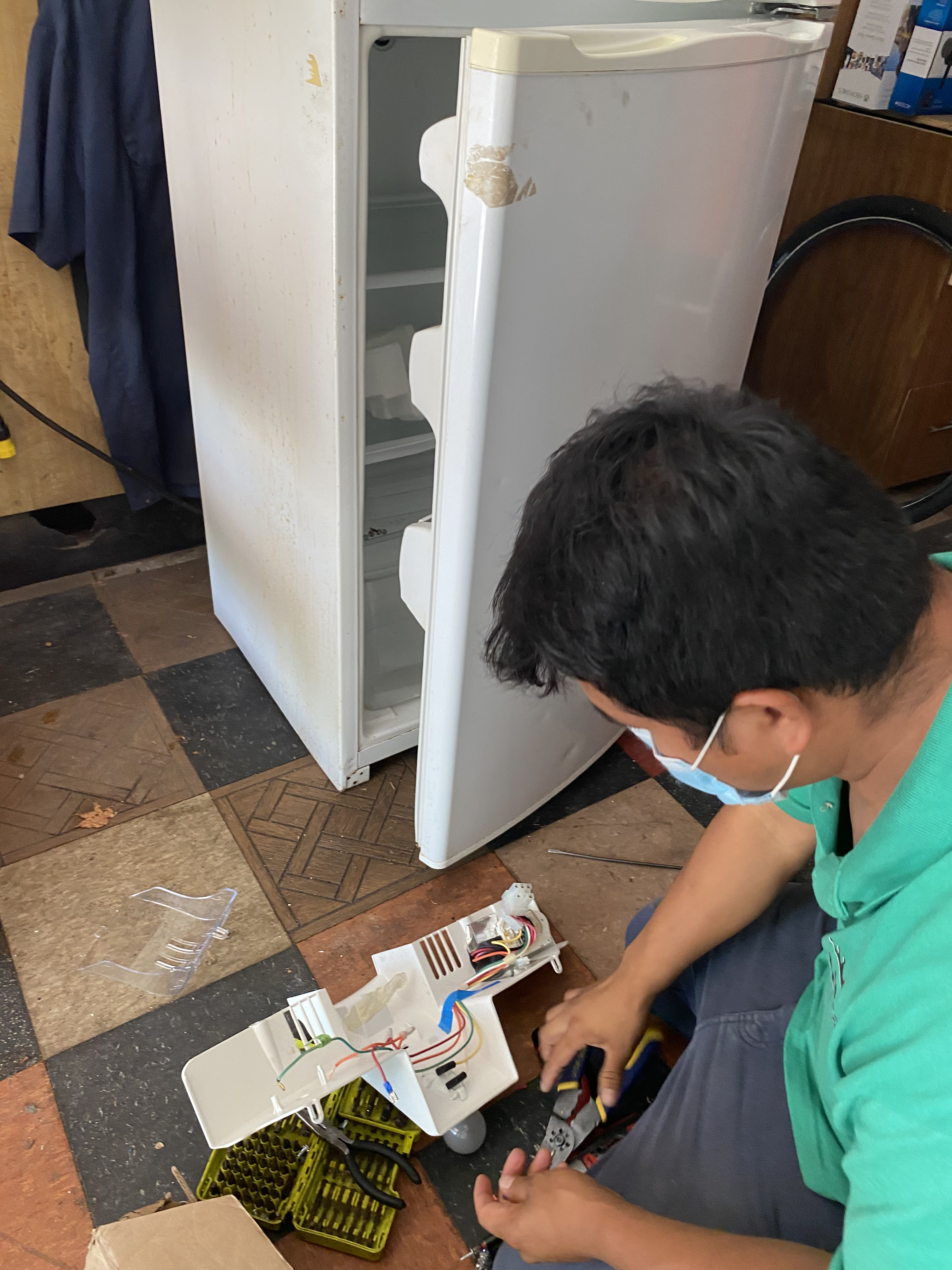 Reyes Appliance Repair technician repairing a refrigerator